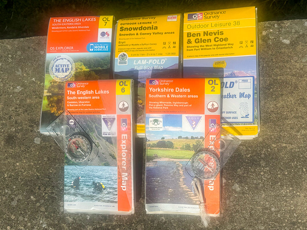 Five OS maps that cover the various routes around the Yorkshire and National Three Peaks, along with the essential compass