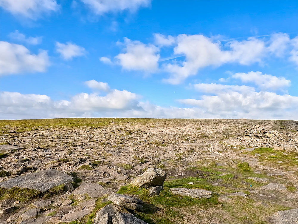 Heading up onto Ingleborough's almost featureless flat summit plateau