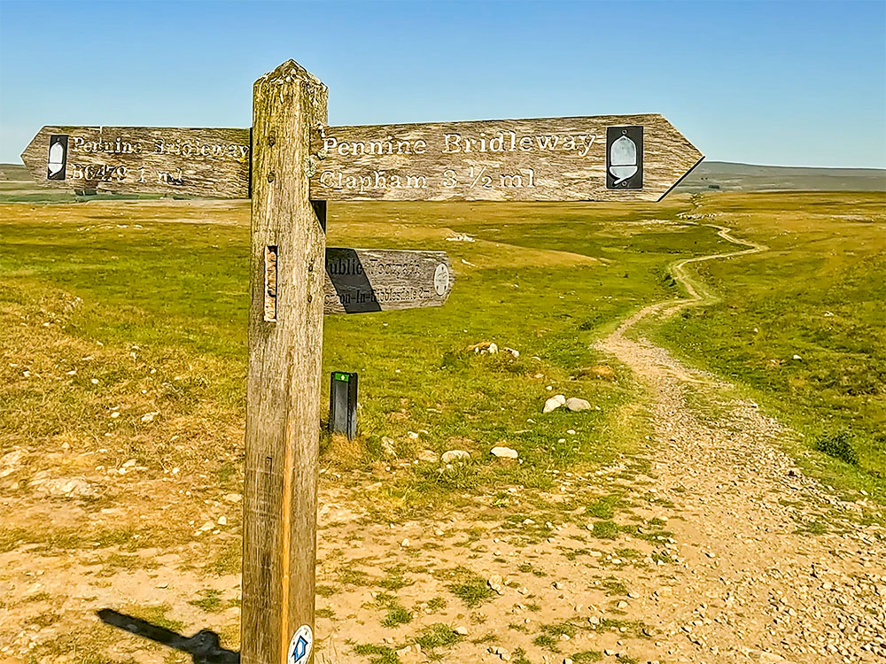 A Yorkshire Three Peaks and Pennine Way sign passed on the Yorkshire Three Peaks walk