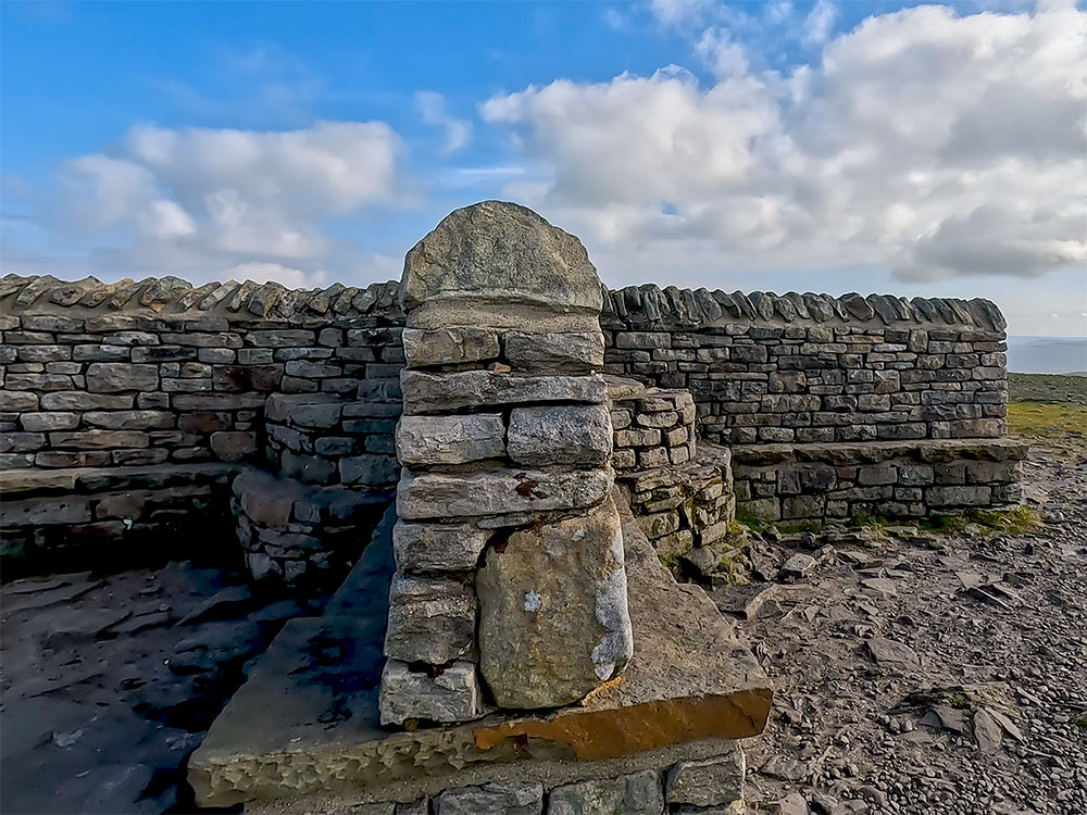 Weather shelter and seating on the summit of Ingleborough