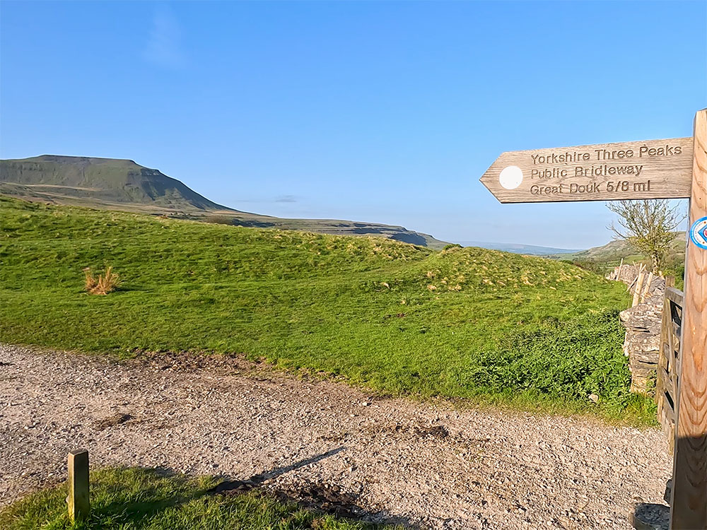 Yorkshire Three Peaks footpath sign on the way up to Ingleborough on the Yorkshire Three Peaks Challenge