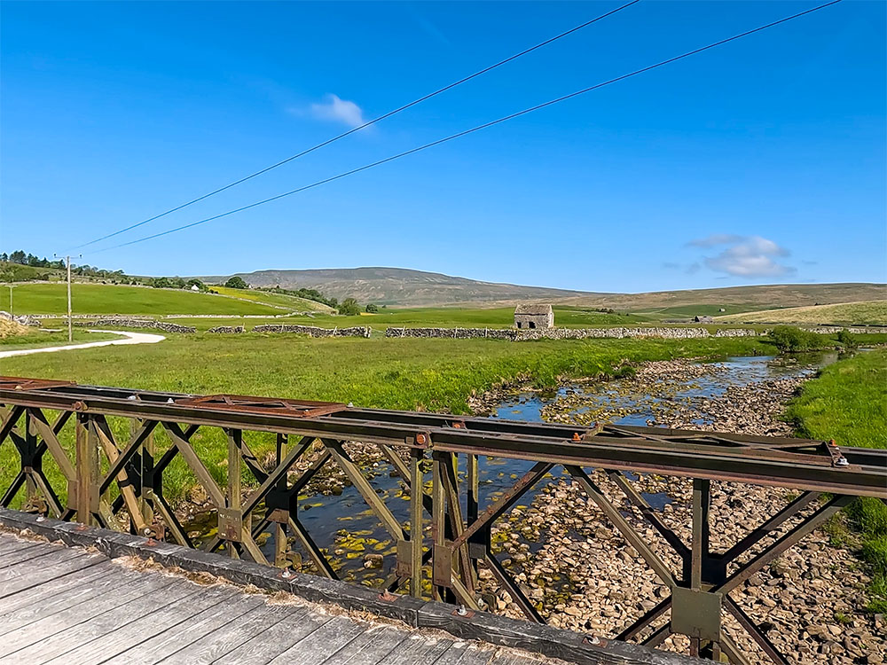 Crossing Gayle Beck on the Yorkshire Three Peaks walk. About one mile downstream where Gayle Beck and Cam Beck meet, they form the start of the River Ribble