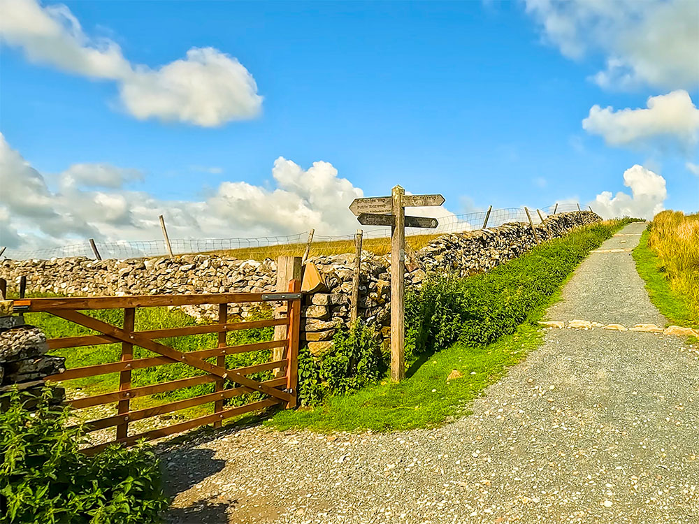 The gate where the Pennine Way leaves the Yorkshire Three Peaks footpath, as it heads down Horton Scar Lane to Pen-y-ghent