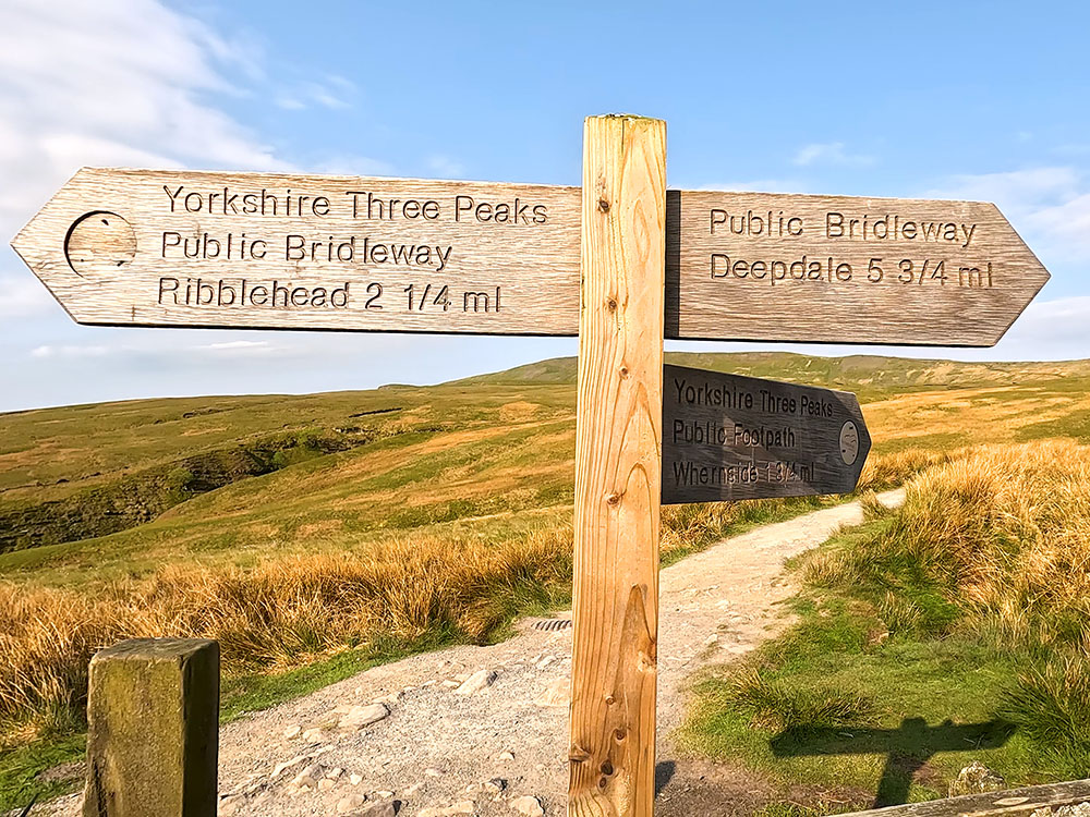 Yorhire 3 Peaks Walk footpath sign to Whernside by the stile