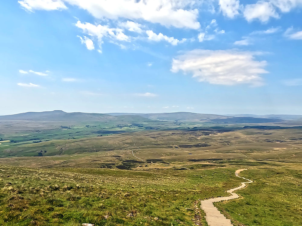 Steps leading down from Pen-y-ghent summit, with path to be followed stretching out ahead