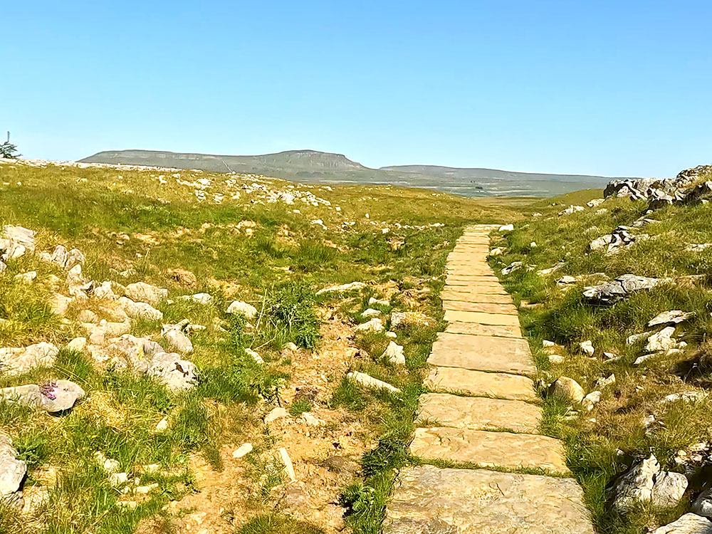 The flagged path with Pen-y-ghent on the horizon