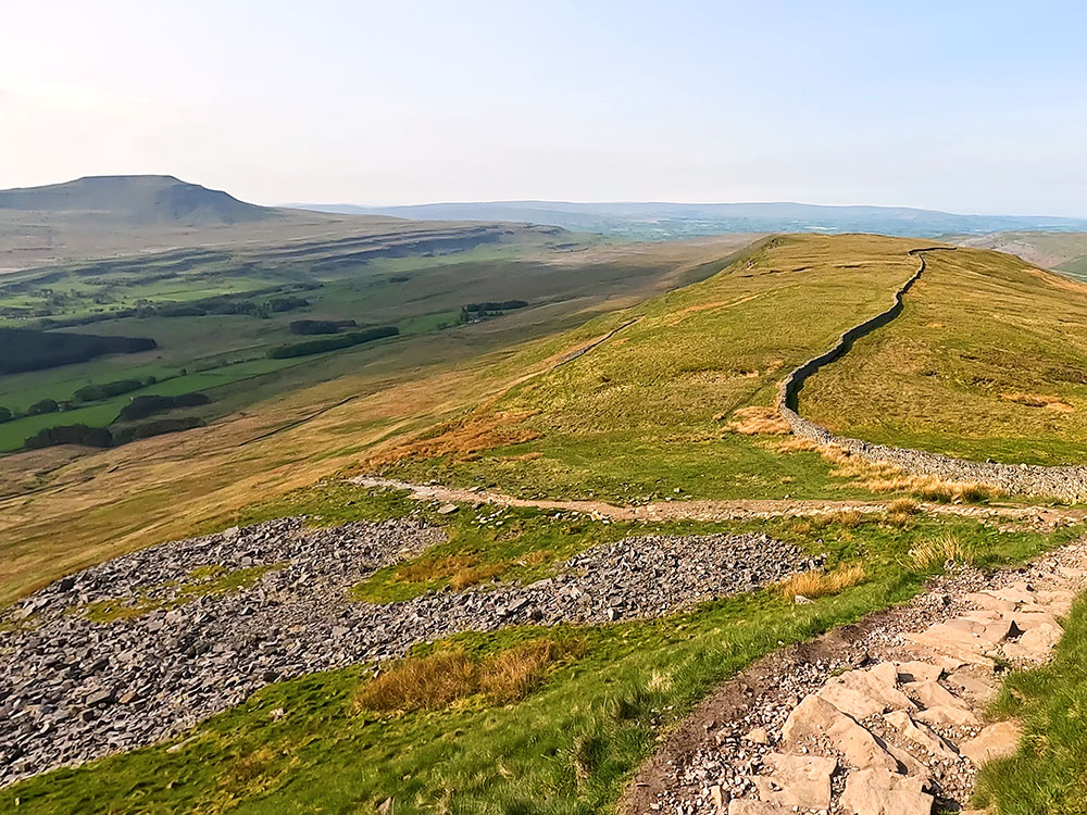 The Yorkshire 3 Peaks path heads away from the wall at the bottom of the steeper section