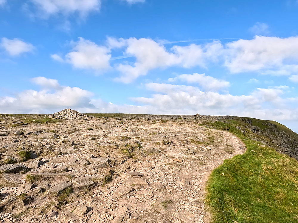 The path past the cairns on Ingleborough's summit plateau