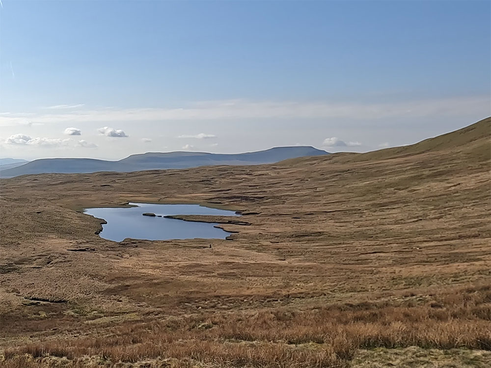 The tarn on Greensett Moss just below Whernside's summit, with Ingleborough in the background