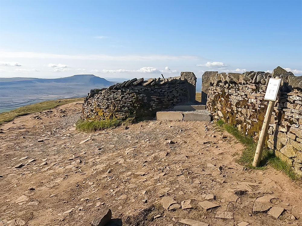 The hole in the wall, through which is the trig point on Whernside's summit